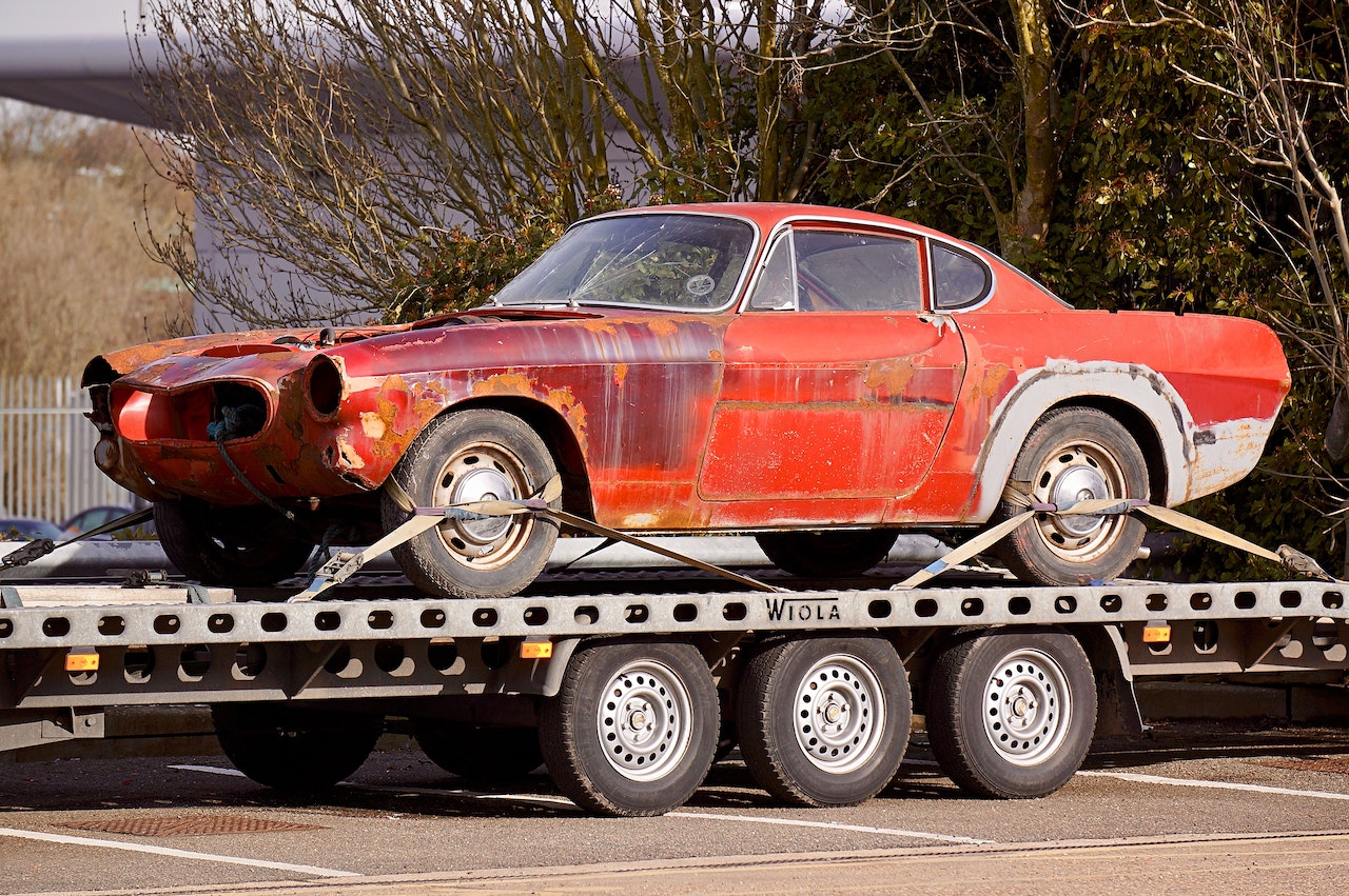 Red Coupe on Flatbed Trailer | Kids Car Donations