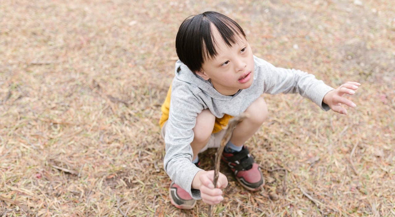 Boy in Gray Long Sleeves Holding a Stick | Kids Car Donations