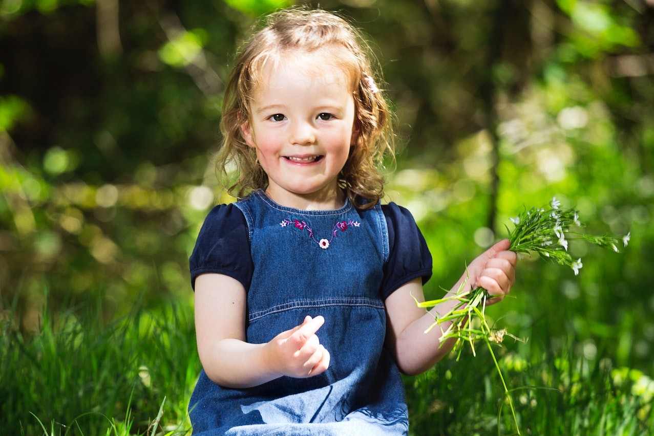 Little Girl Sitting on Grass | Kids Car Donations