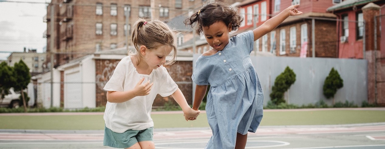 Little Girls Holding Hands and Jumping on a Court | Kids Car Donations