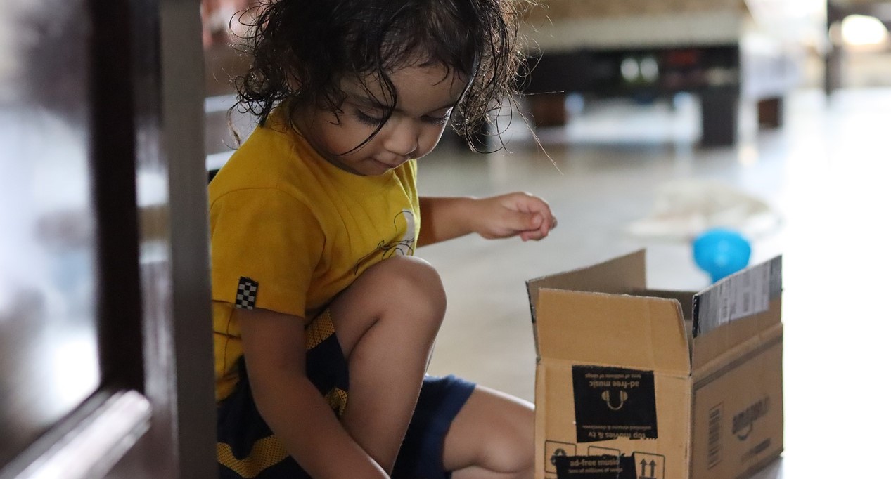 Kid Opening a Box | Kids Car Donations