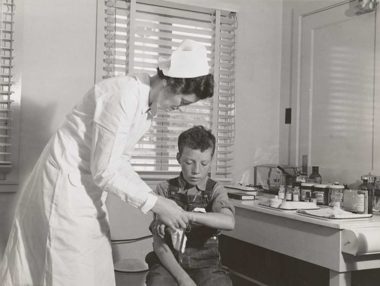 Old Photo of a Nurse Attending a Kid | Kids Car Donations