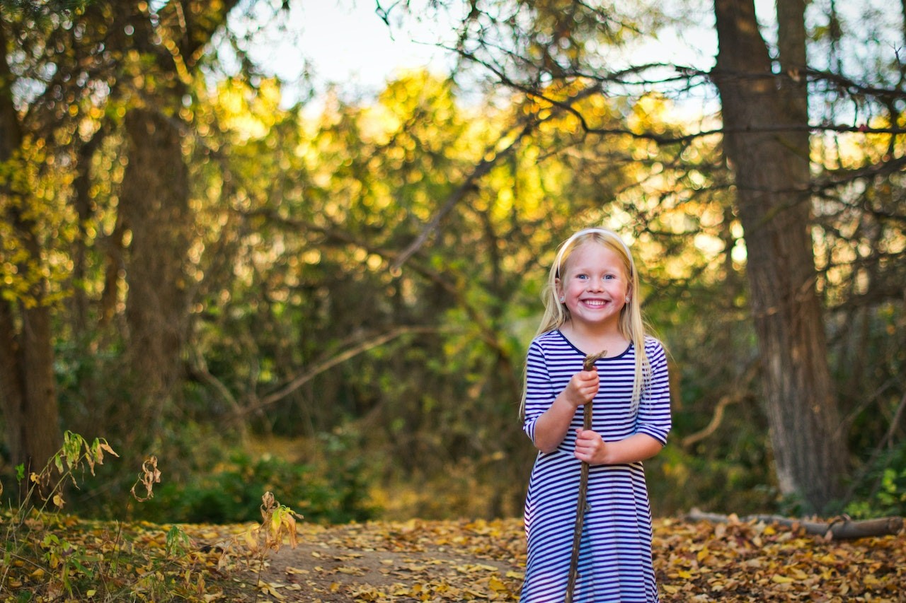 Girl Standing Near Trees | Kids Car Donations