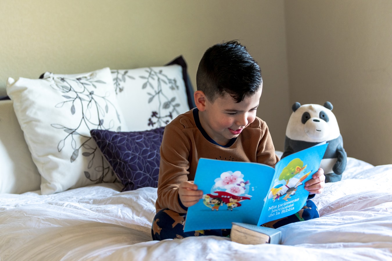 Kid Reading a Book on Bed
