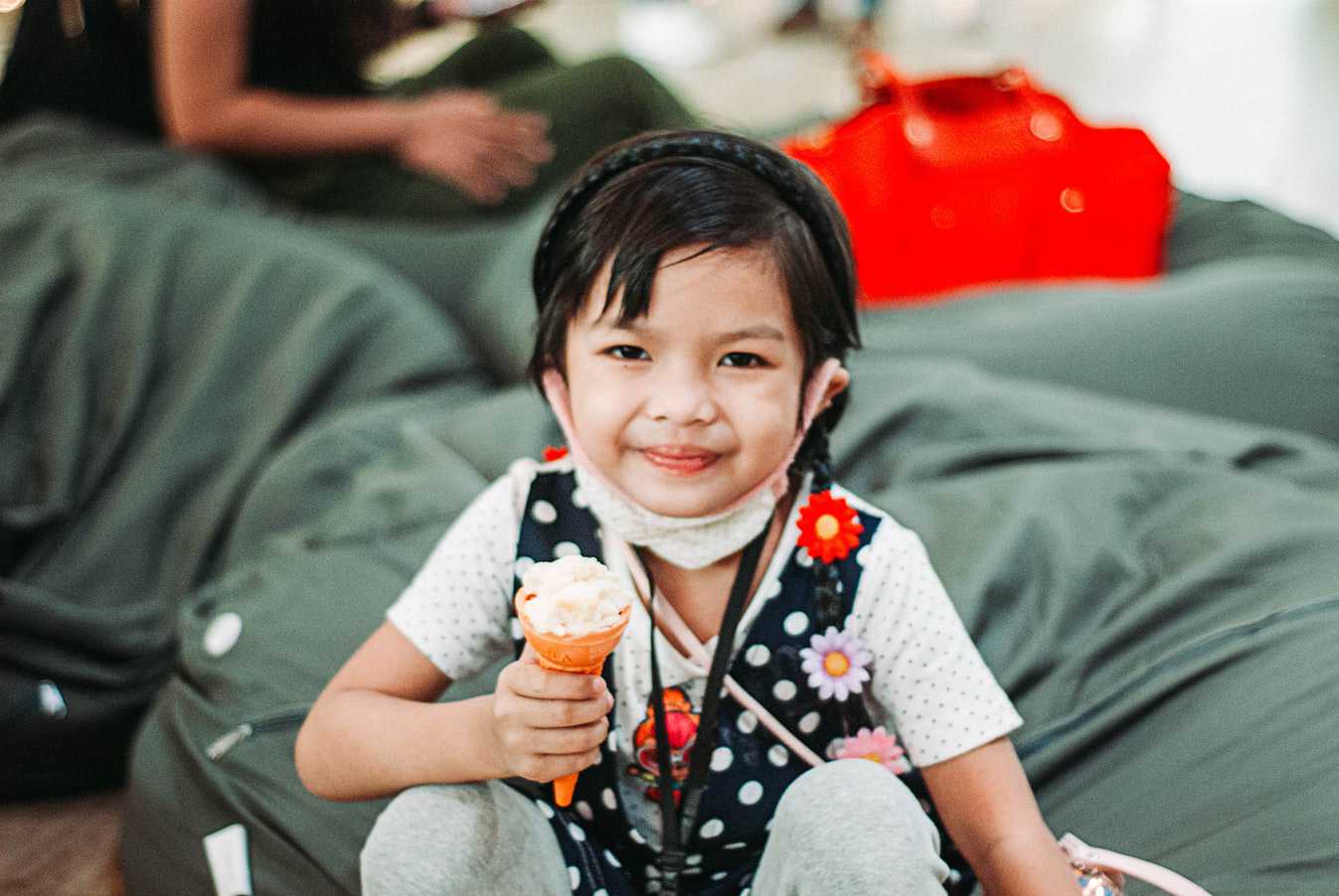 Kid With Face Mask Holding an Ice Cream Cone | Kids Car Donations