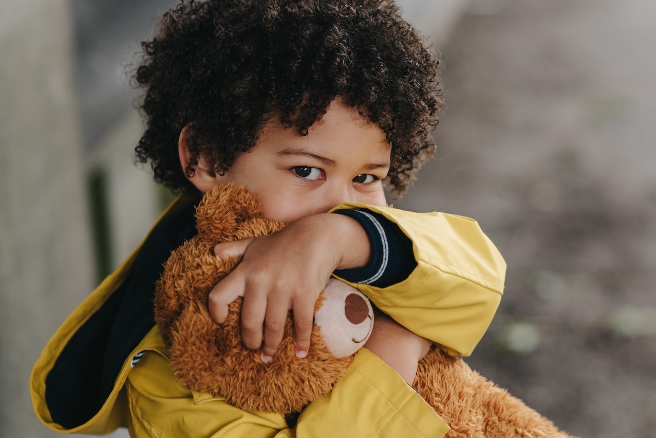 Kid Hugging a Teddy Bear | Kids Car Donations