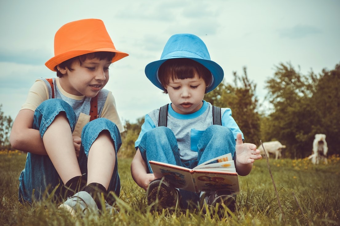 Kids Sitting On Green Grass Field | Kids Car Donations