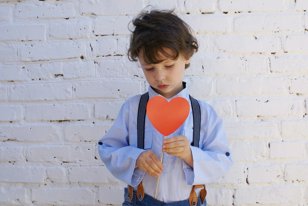 Photo of Boy Holding Heart-shape Paper on Stick | Kids Car Donations
