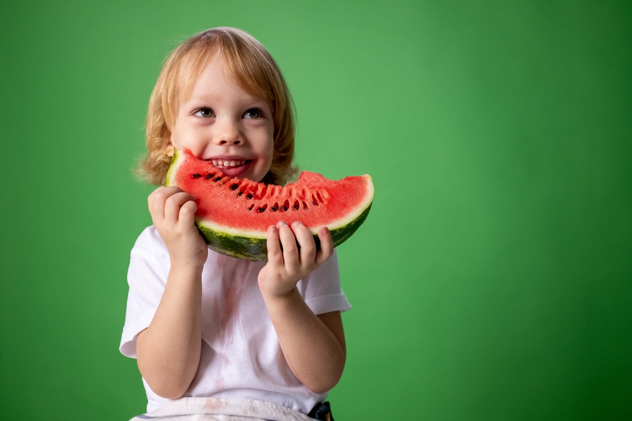 Kid Holding a Slice of Watermelon | Kids Car Donations