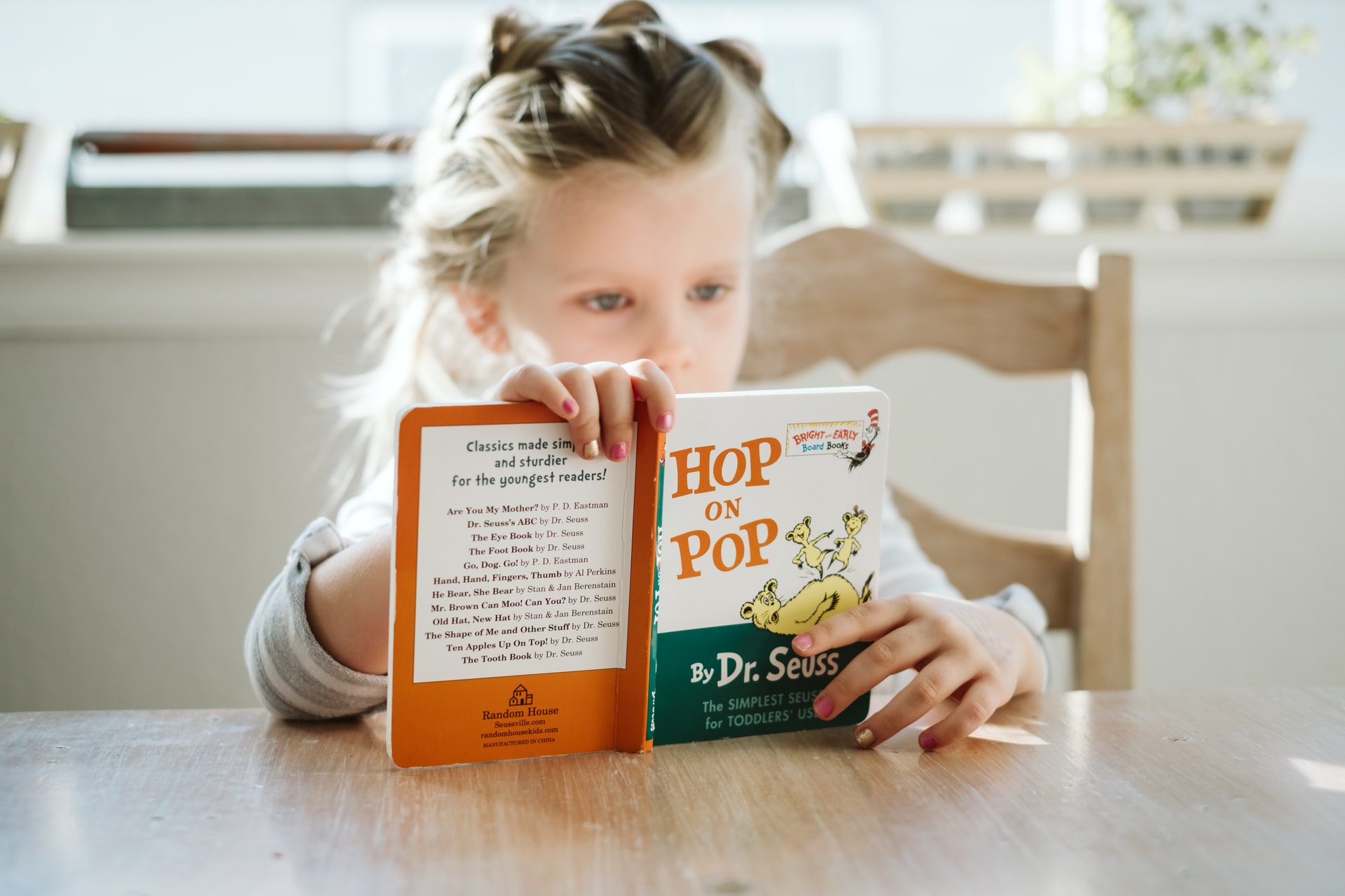 Kid Reading Dr. Seuss’s Hop On Pop | Kids Car Donations