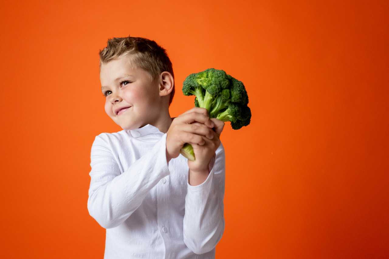Kid Holding a Broccoli | Kids Car Donations
