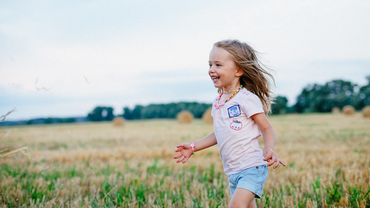 Girl running while laughing | Kids Car Donations