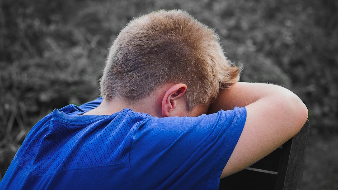 Sad child sitting on a chair | Kids Car Donations