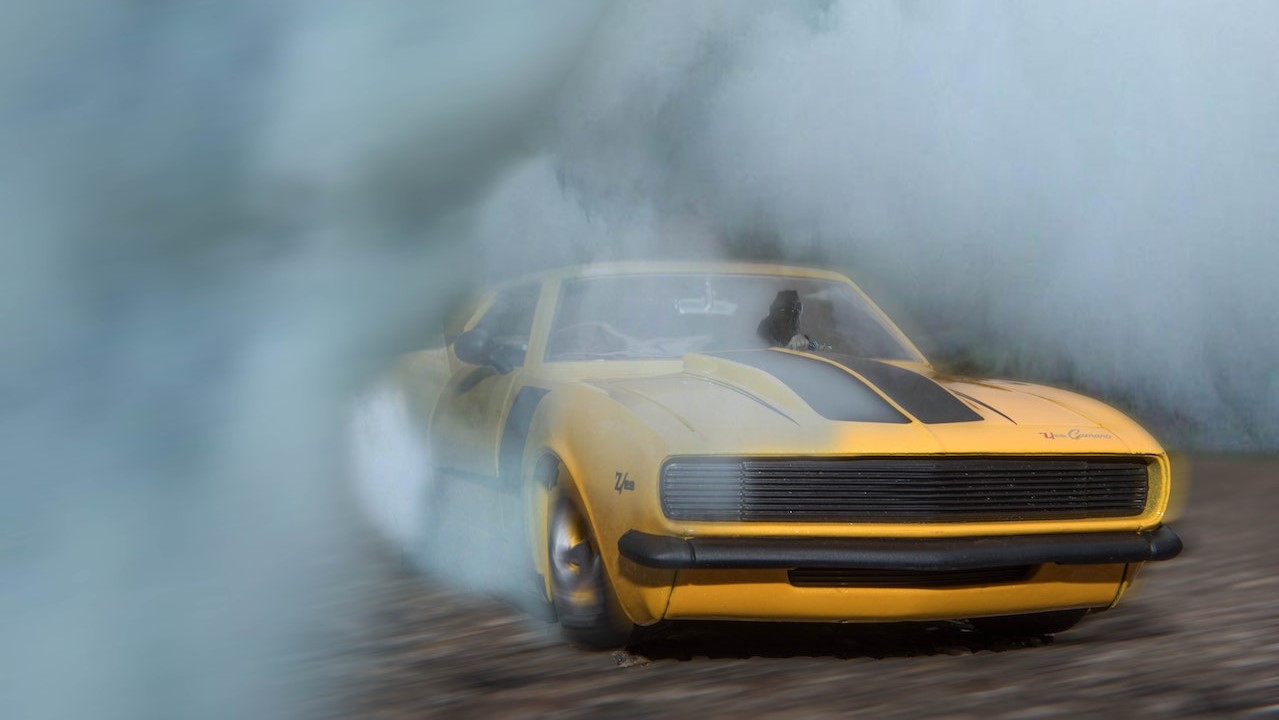 Classic Yellow And Black Sports Car Drifting On Road With Smoke | Kids Car Donations