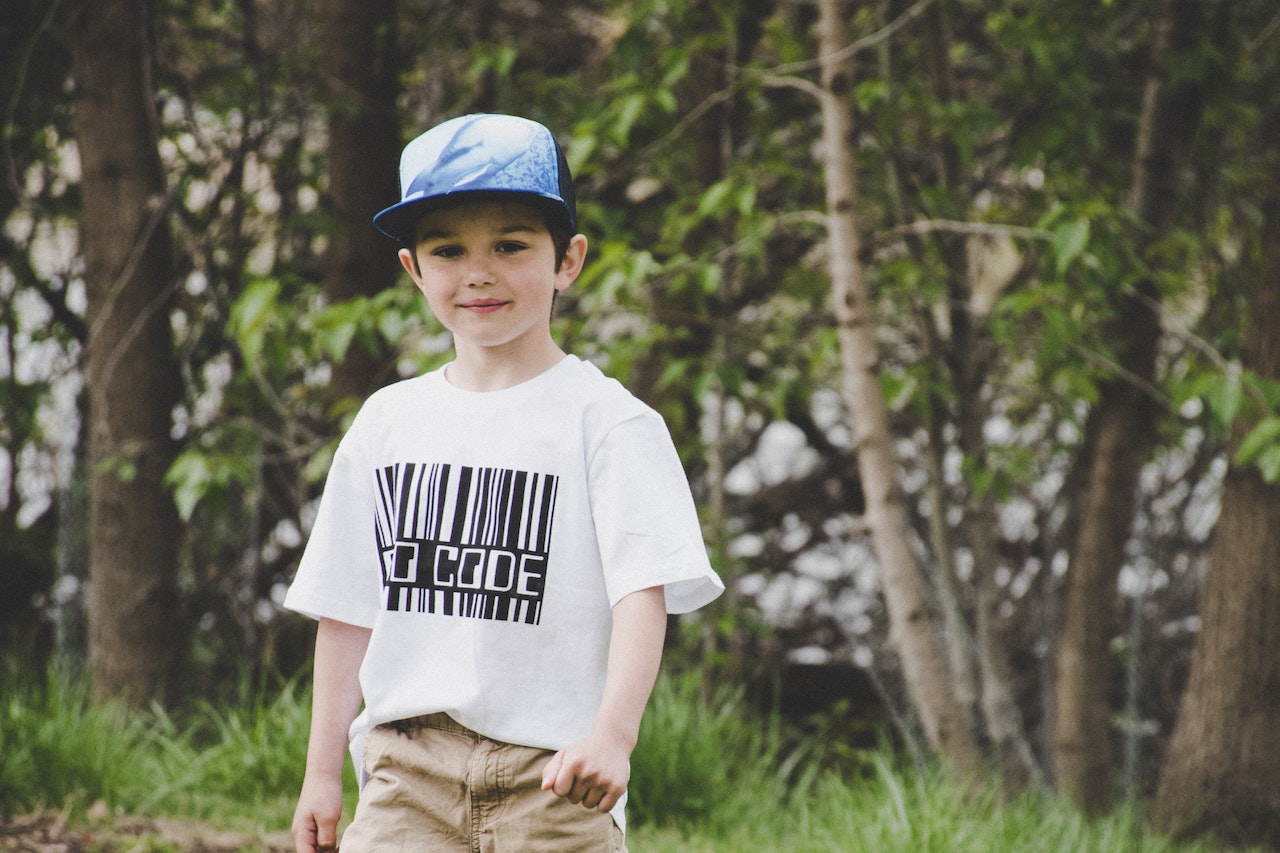 Boy In White Shirt And Blue Fitted Cap | Kids Car Donations