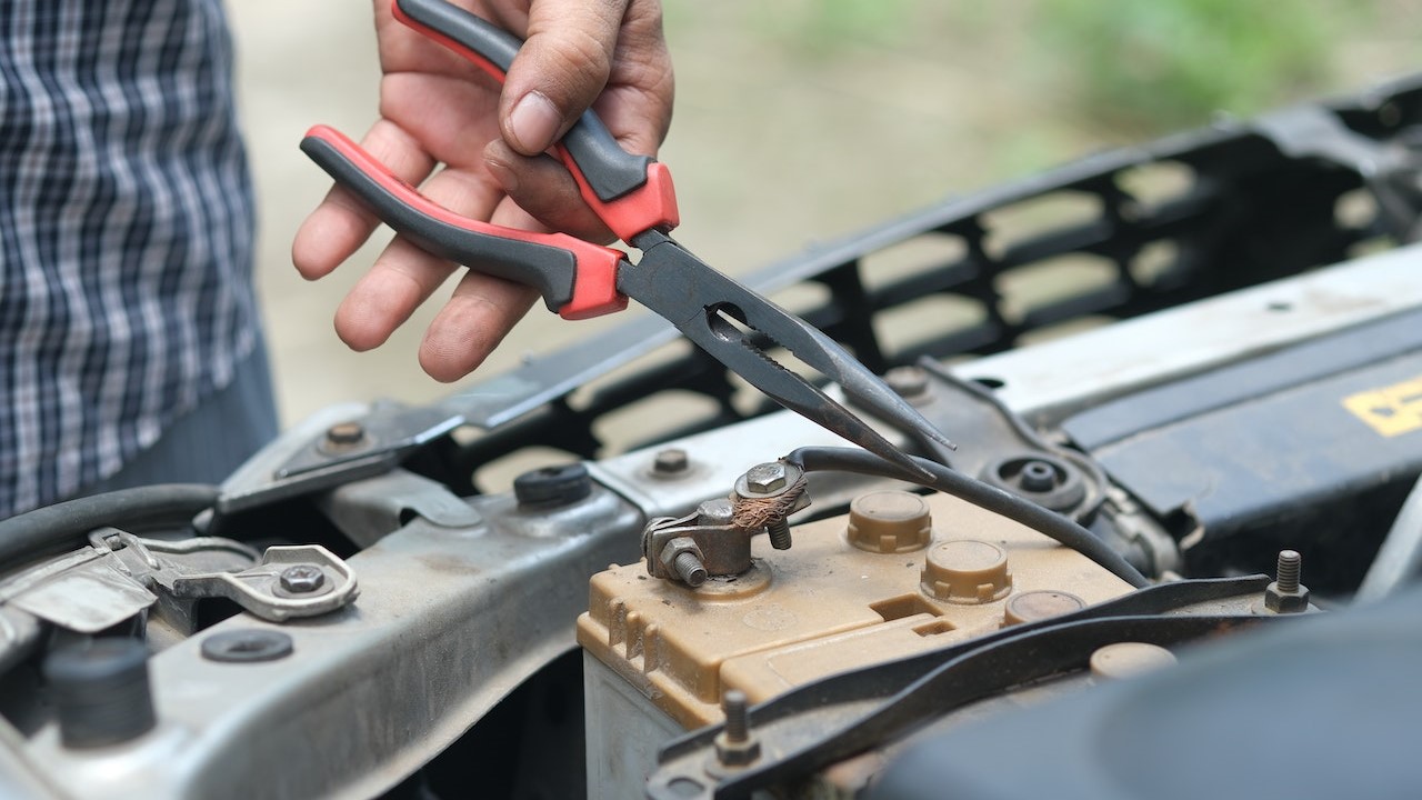 Person Holding Red and Black Hand Tool | Kids Car Donations