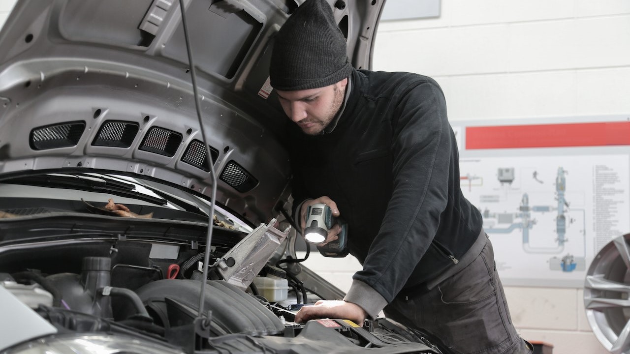 Man in Black Jacket Inspecting Car Engine | Kids Car Donations