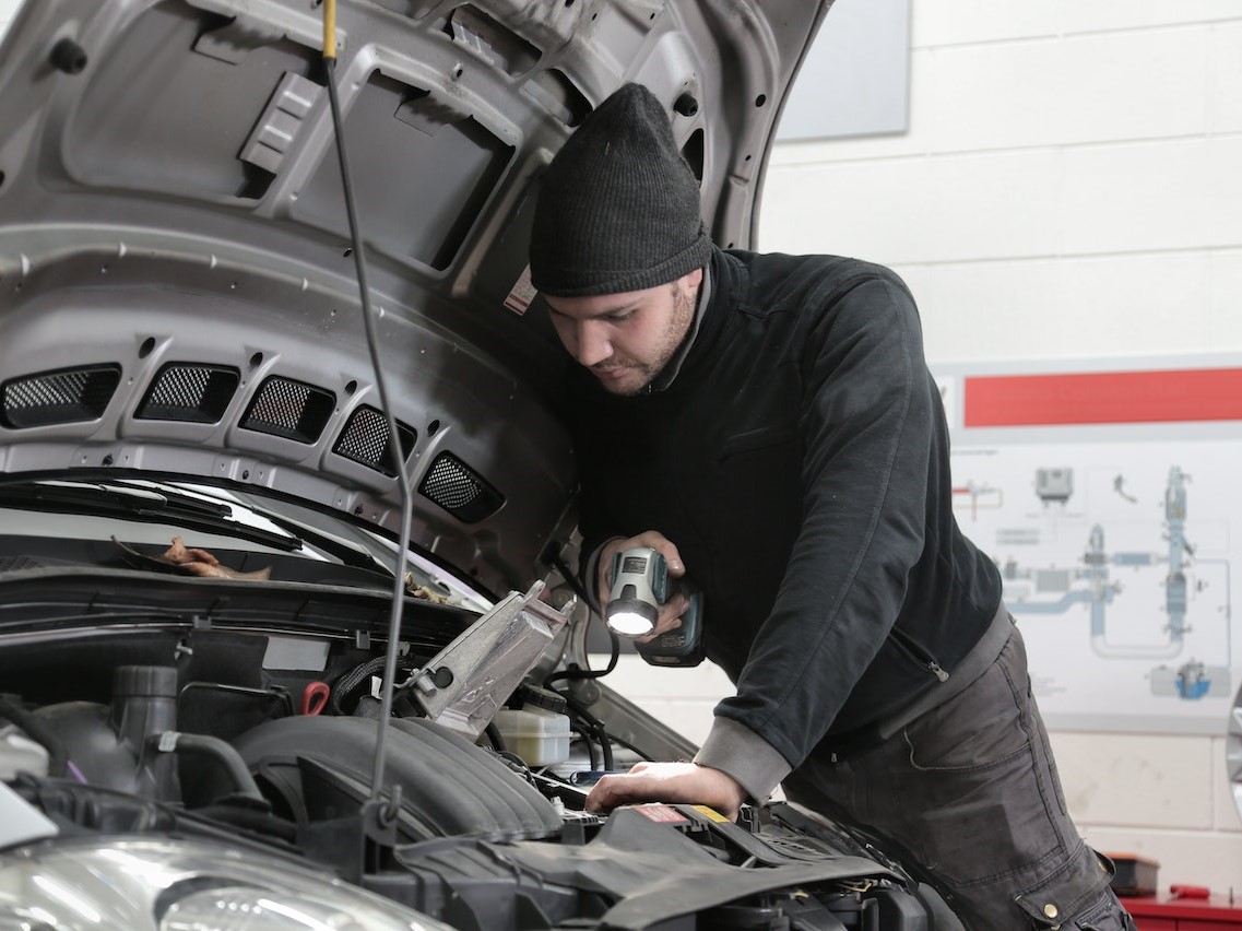 Cap Inspecting Car Engine | Kids Car Donations