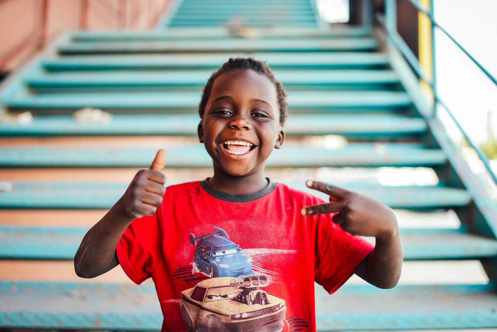 Smiling Kid Wearing Red Shirt | Kids Car Donations