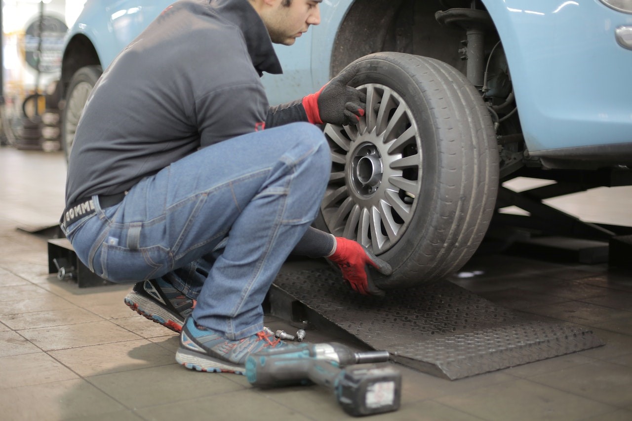 Man Changing a Car Tire | Kids Car Donations