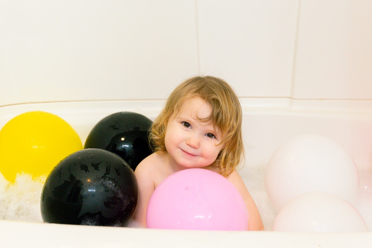 Photo Of Child Surrounded By Balloons | Kids Car Donations