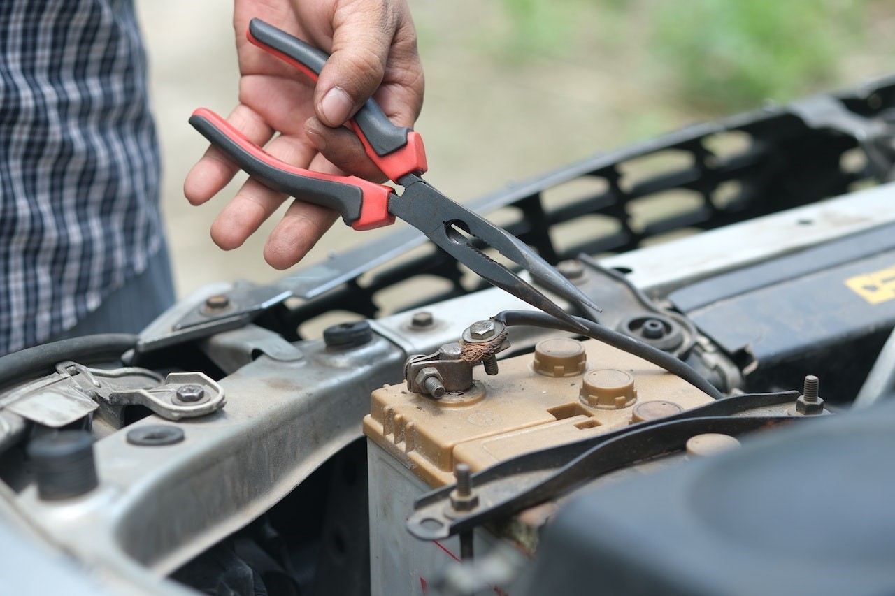 A Person Holding Red and Black Hand Tool | Kids Car Donations