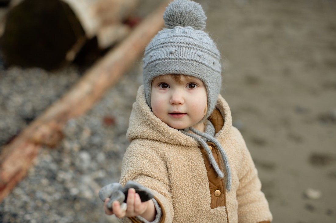 Child In Brown Coat And Gray Knit Cap Holding Rocks | Kids Car Donations