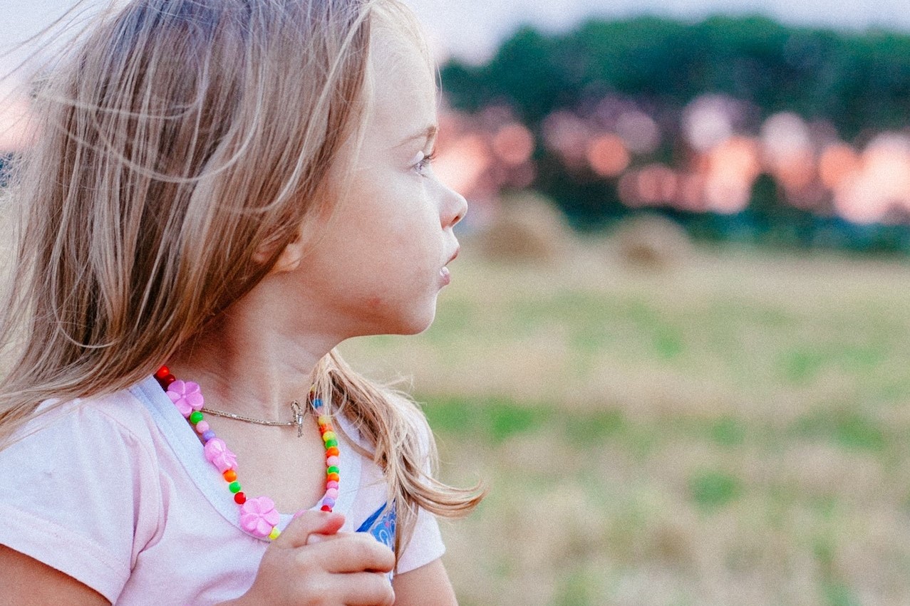 Selective Focus Photography of Girl on Grass Field | Kids Car Donations