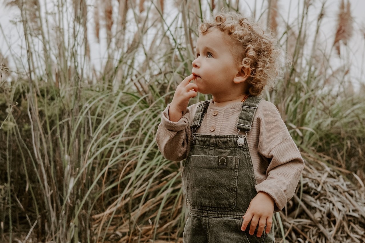 Child Standing near Rushes | Kids Car Donations