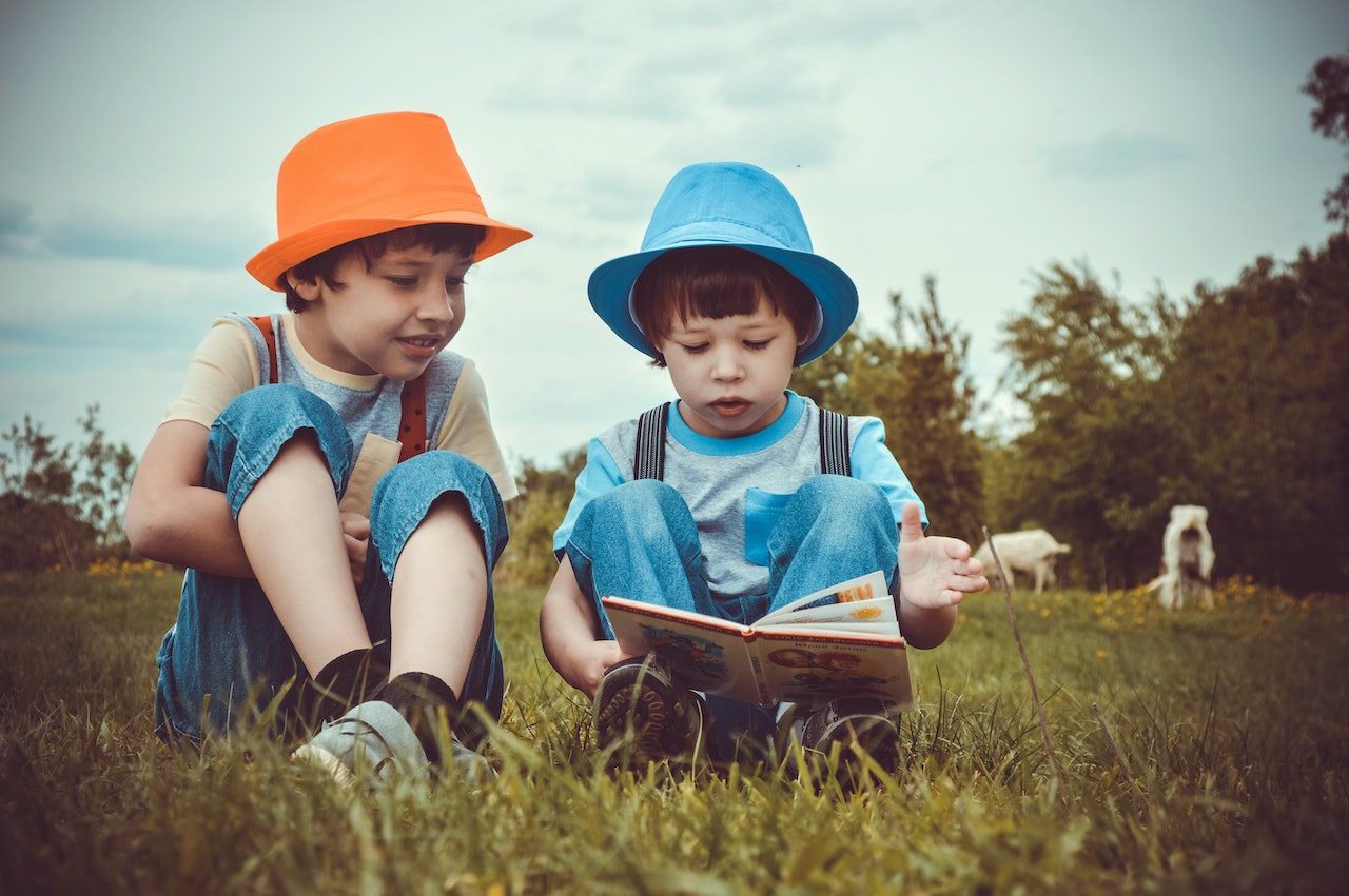 two kids sitting on field | Kids Car Donations