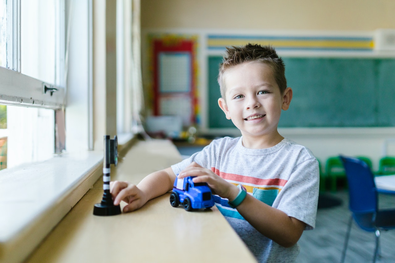 Boy Playing with Blue Car Toy | Kids Car Donations