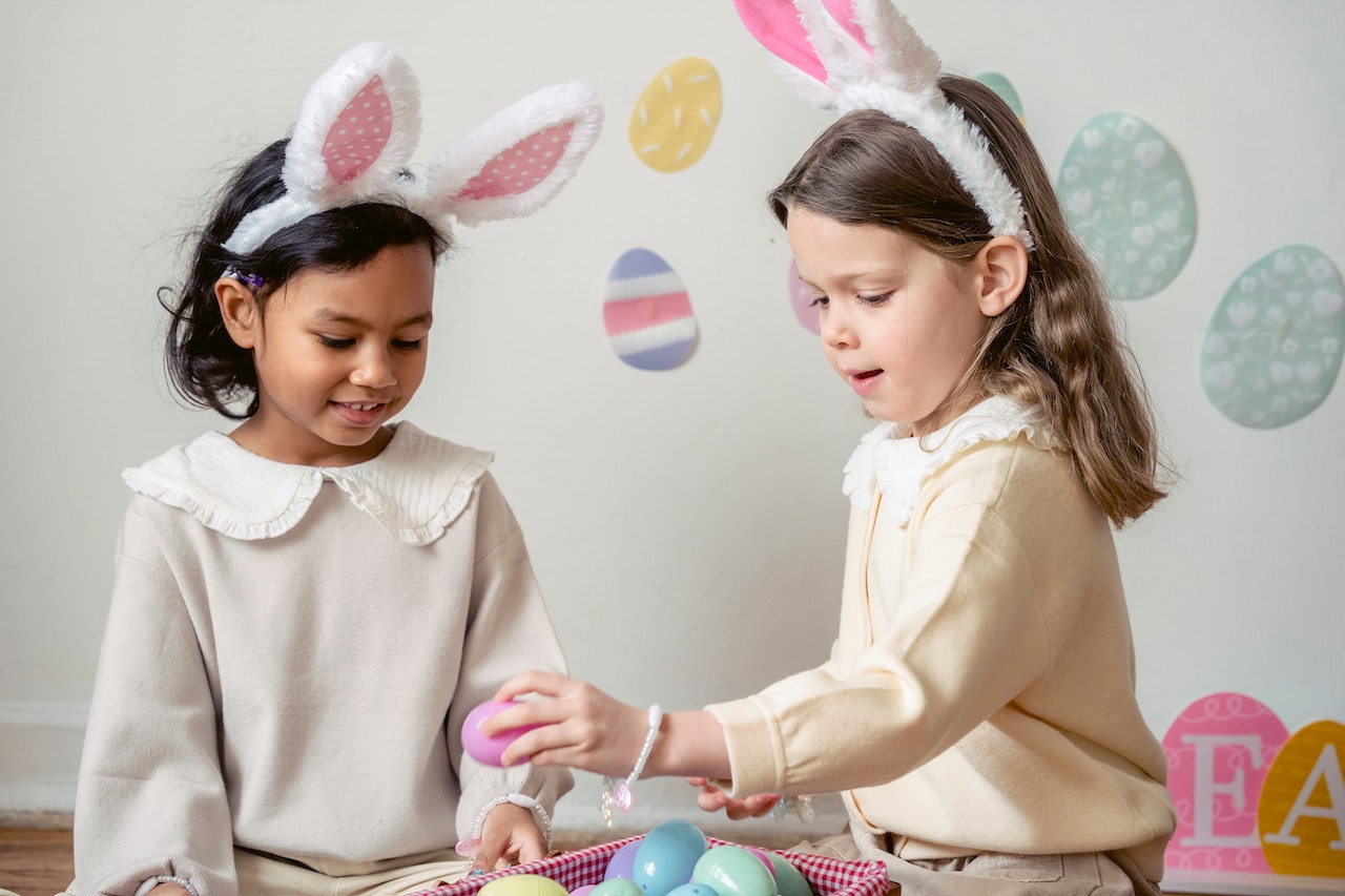 Happy diverse girls in bunny ears playing with eggs | Kids Car Donations