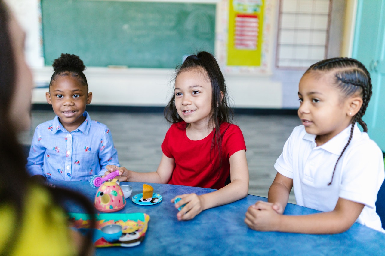 Three Girls Sitting at the Table | Kids Car Donations