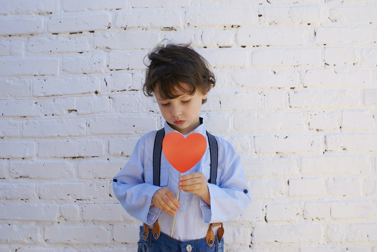 Boy Holding Heart-shape Paper on Stick | Kids Car Donations