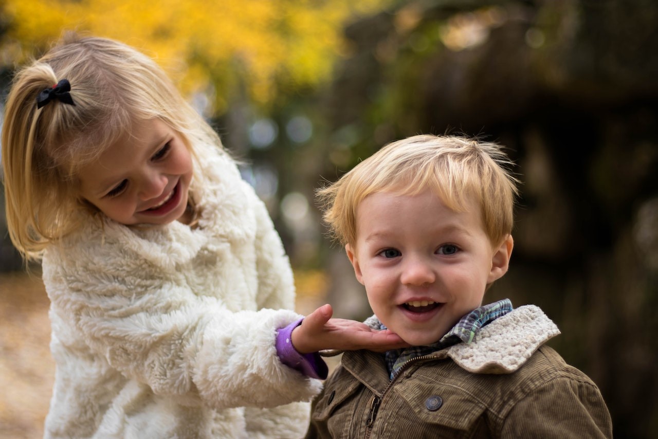 Girl Holding the Chin of Boy Outdoor | Kids Car Donations