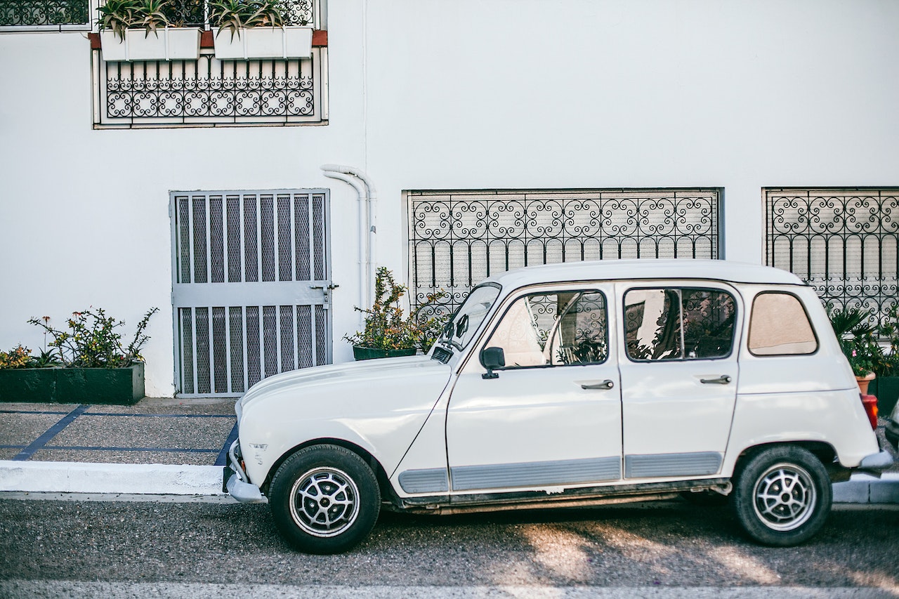 Retro car parked near asphalt sidewalk in front of building | Kids Car Donations