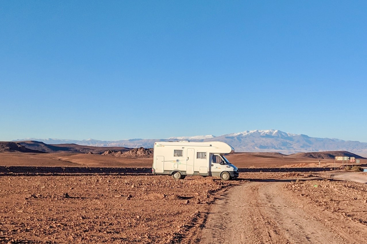 White Campervan on Dirt Road | Kids Car Donations