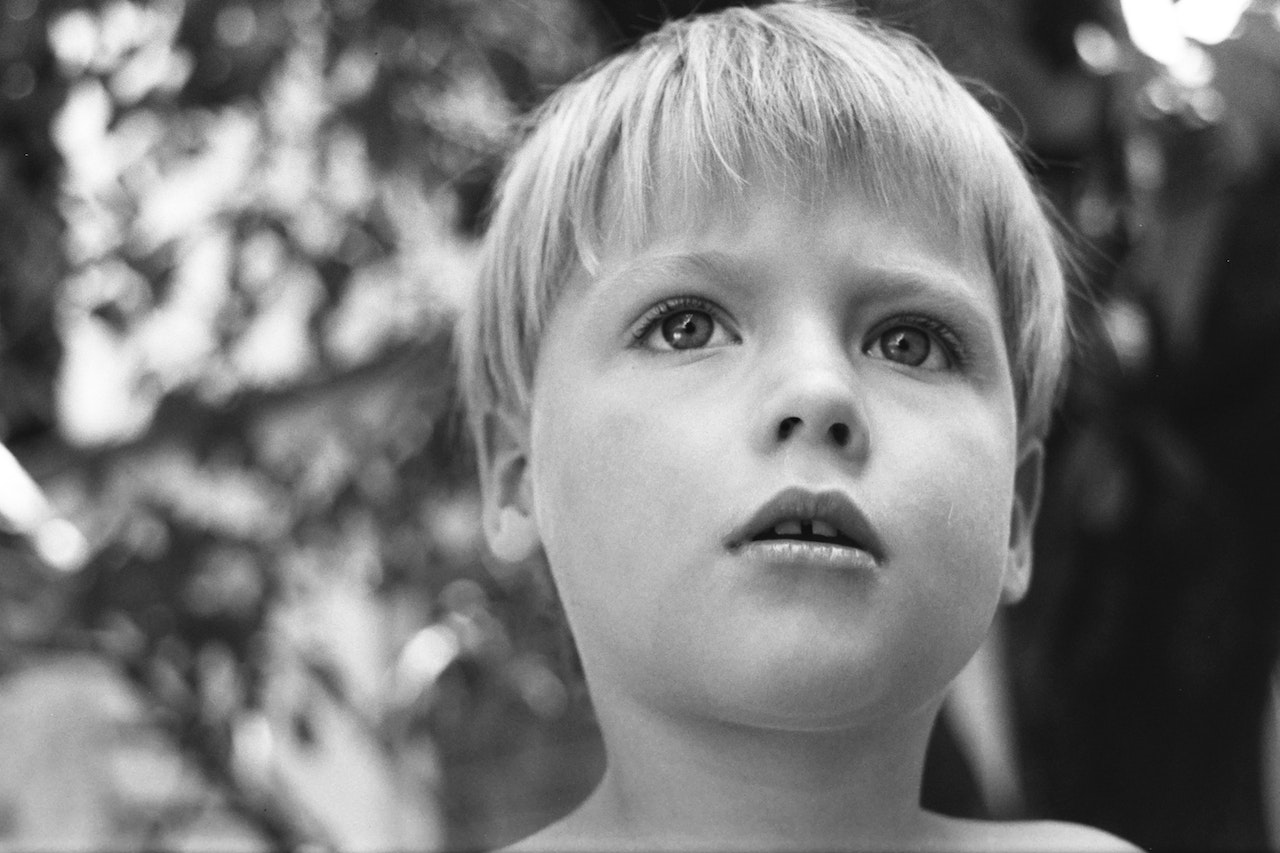 Grayscale Photo of Boy's Face | Kids Car Donations