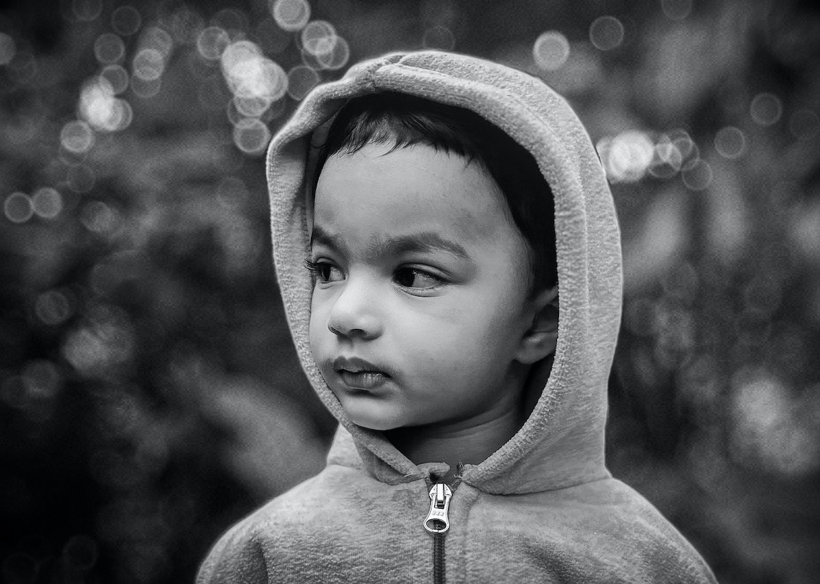 Grayscale Photo of a Boy Wearing Jacket | Kids Car Donations