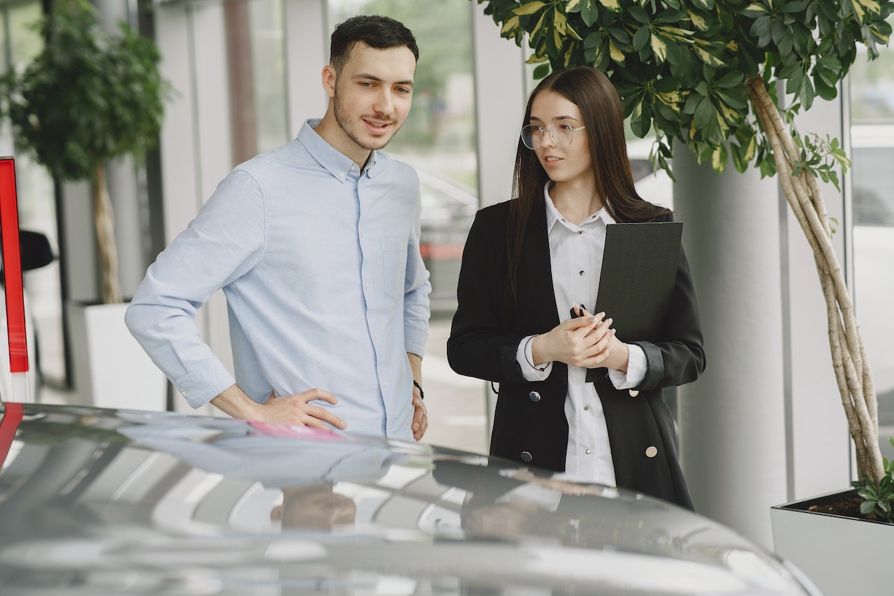 Man and Woman Looking at a Car | Kids Car Donations