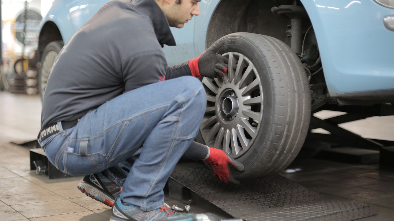 Man changing tire of his car | Kids Car Donations