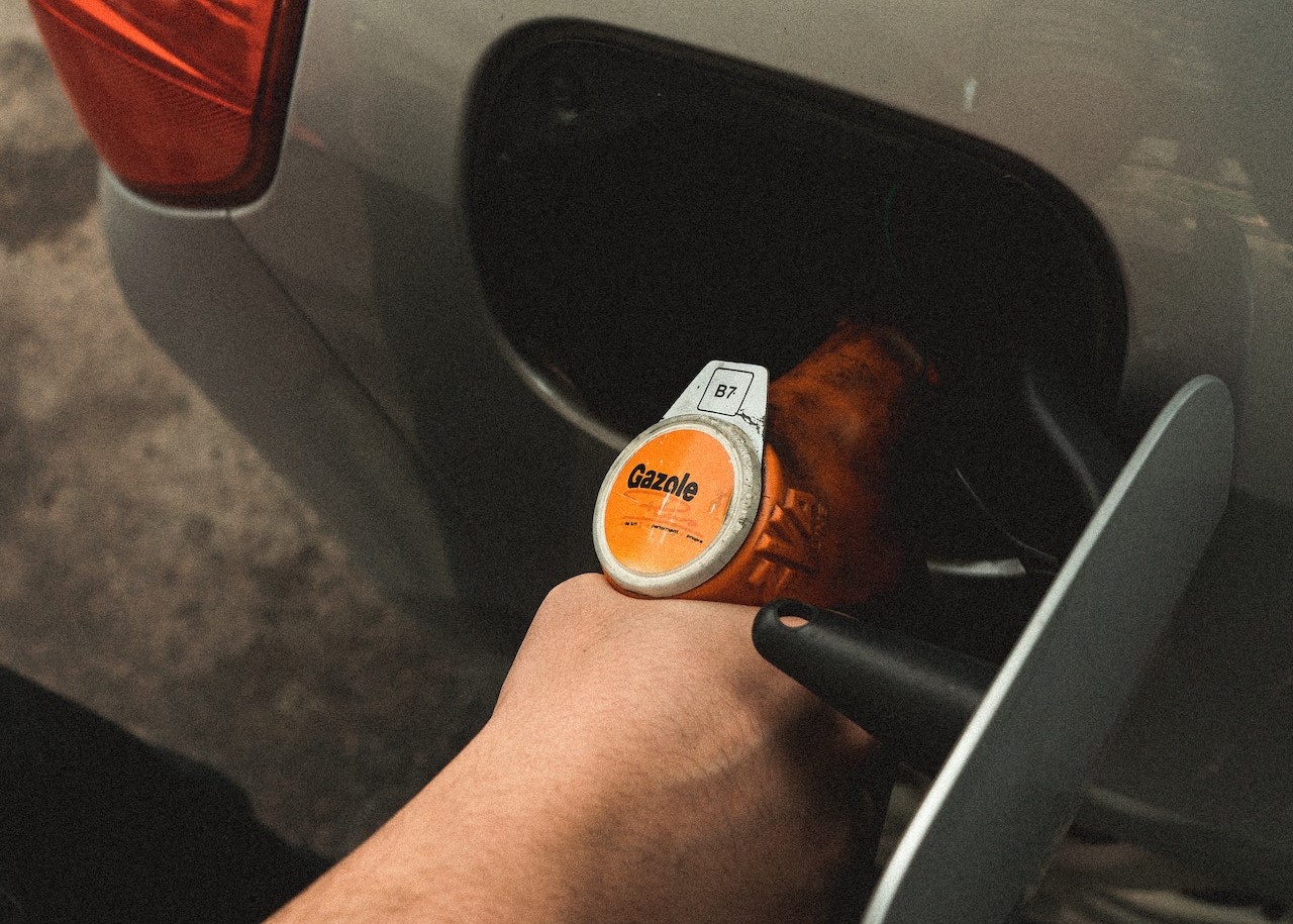 Person Refilling Gasoline on Gas Tank | Kids Car Donations