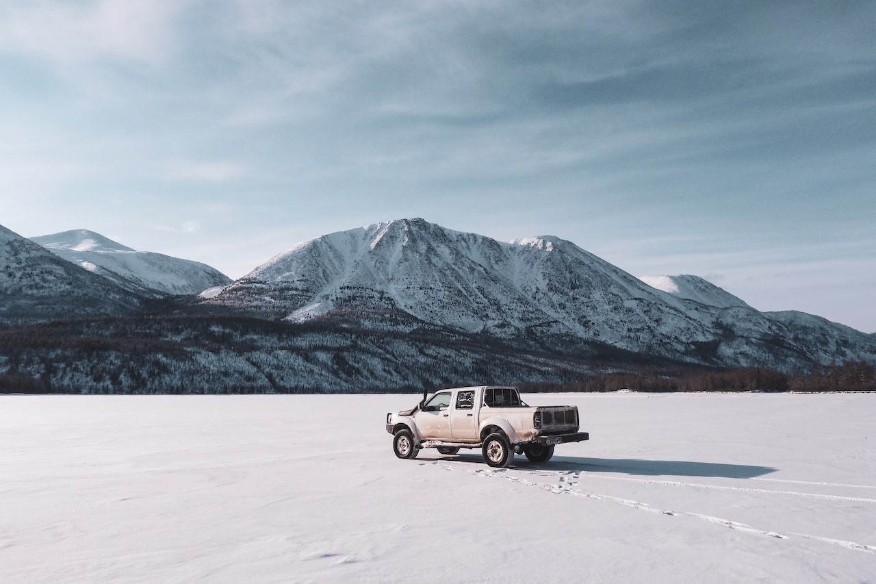 Vehicle on Snow Covered Field Near Mountains | Kids Car Donations