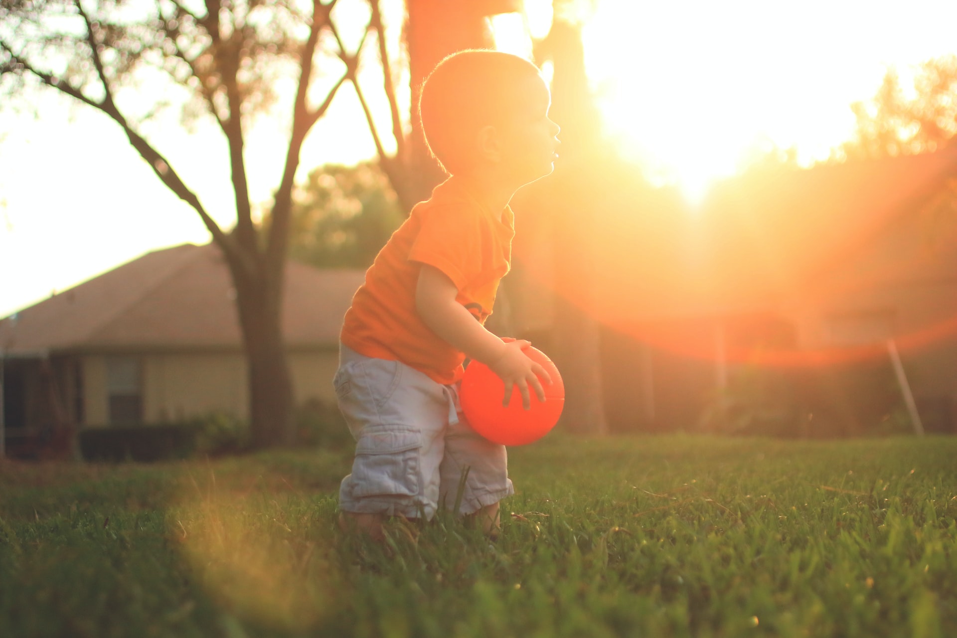 Boy Holding Orange Balloon | Kids Car Donations