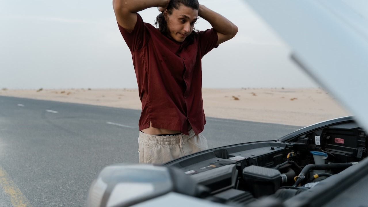 Man standing in front of his broken car | Kids Car Donations