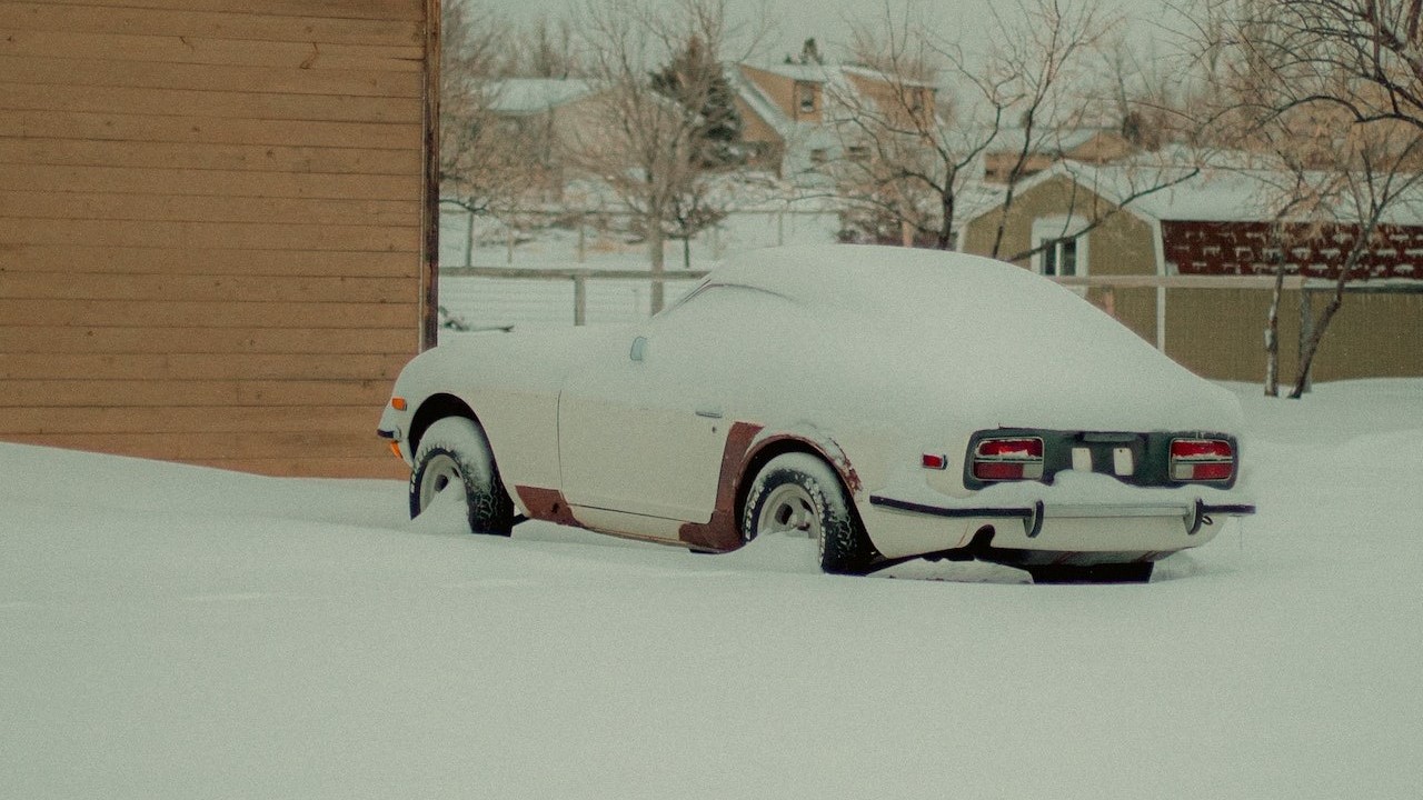 Parked white car covered in snow | Kids Car Donations