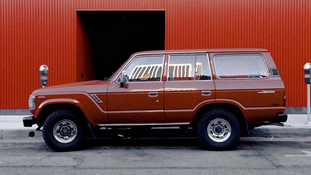 Toyota land cruiser parked near a red building | Kids Car Donations