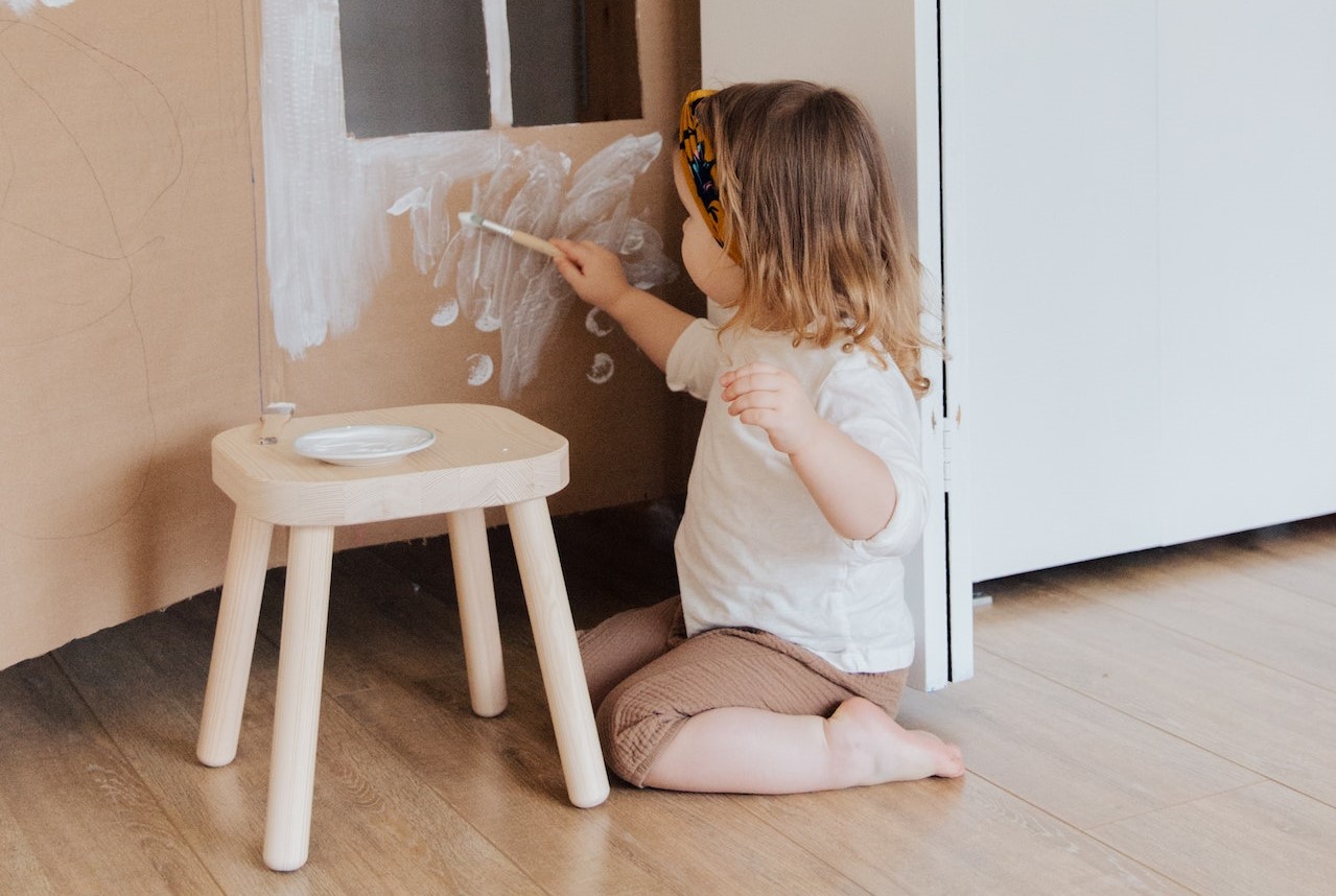 Girl Painting Cardboard House | Kids Car Donations