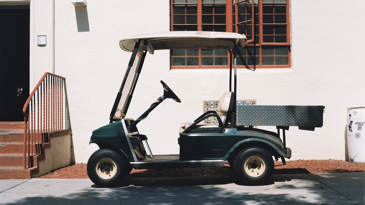 Green golf cart parked | Kids Car Donations