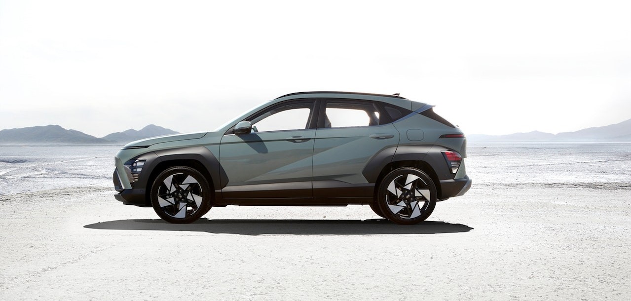 The Hyundai KONA standing in front of a blurry landscape | Kids Car Donations